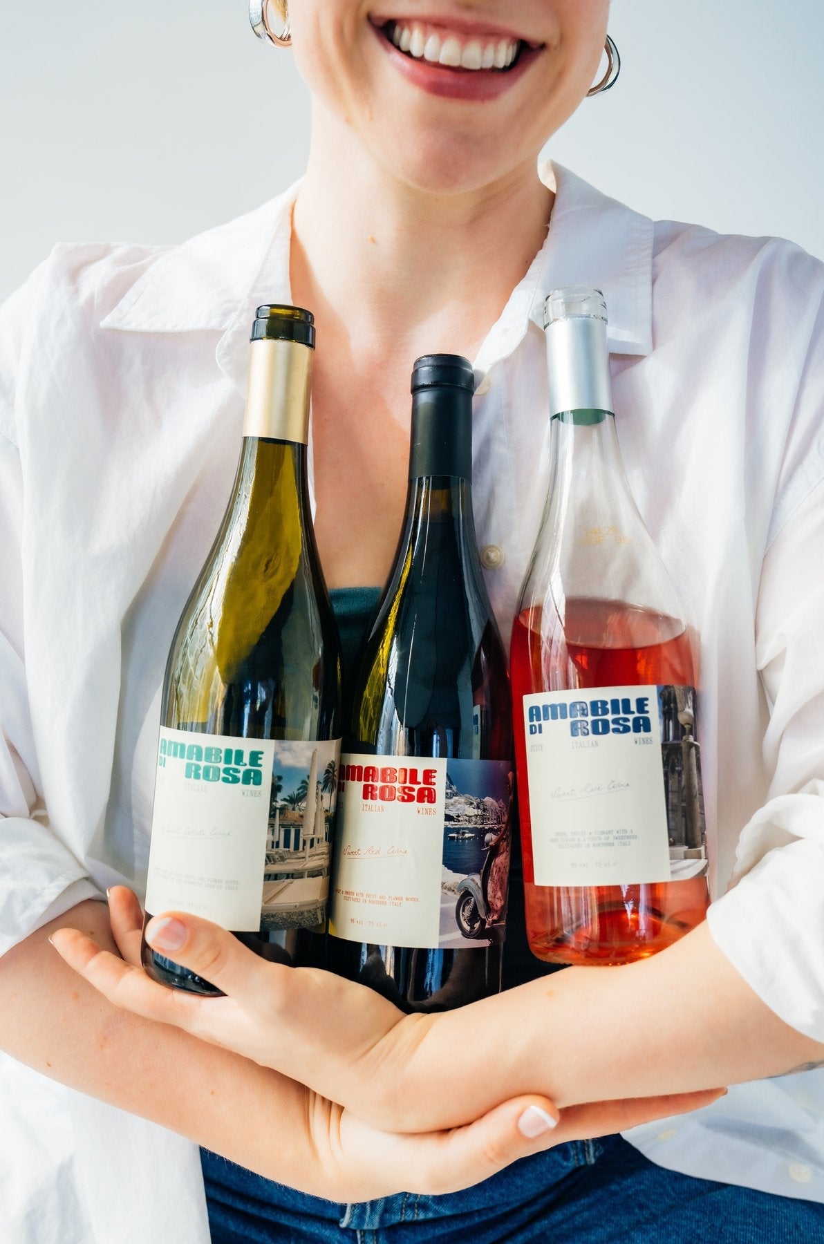 Friends holding all three Amabile di Rosa bottles together
