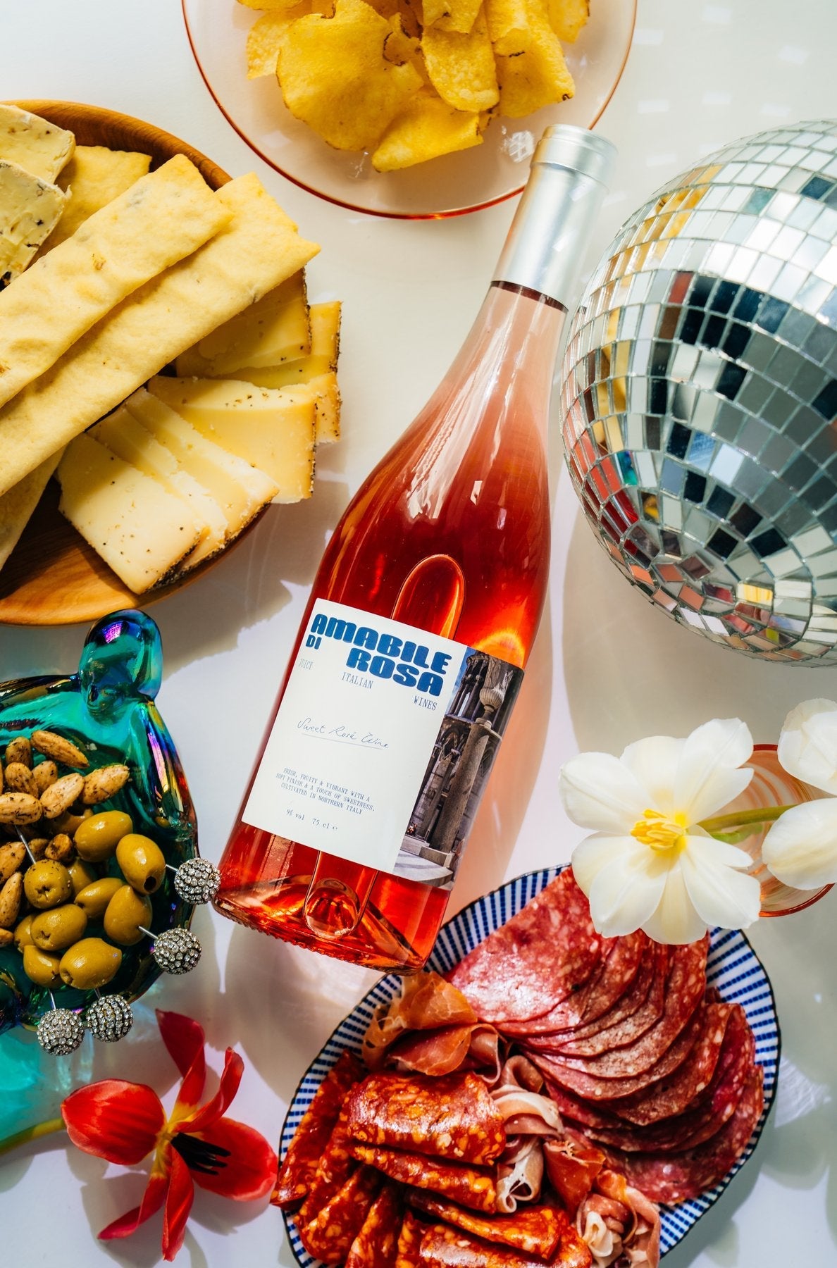Amabile di Rosa Rosato styled with cheese, olives and disco ball
